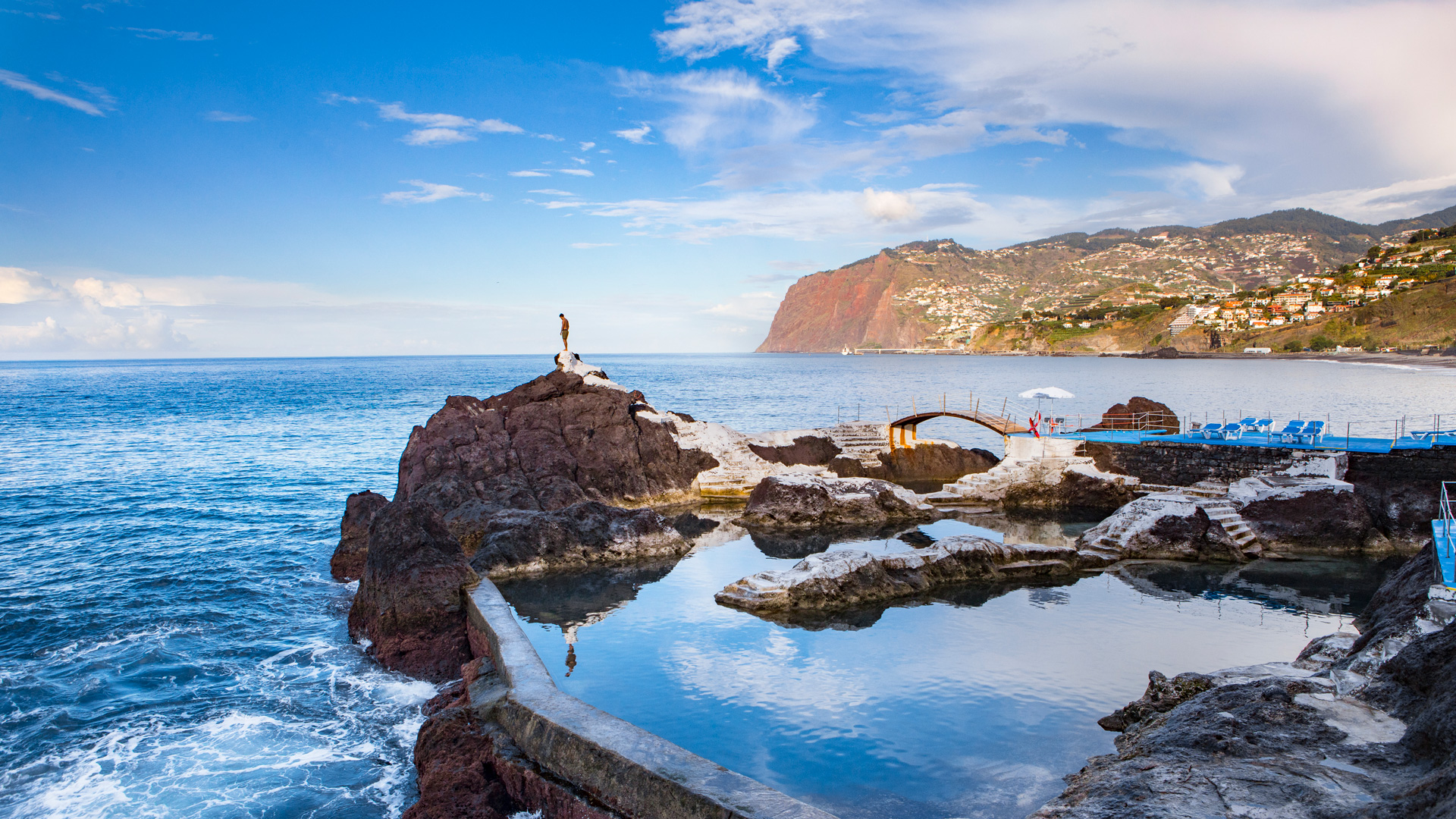 Dramatic Atlantic coastline of Madeira island with sheer volcanic cliffs plunging into the sea — Madeira Grand Experience scenic route, PT-31
