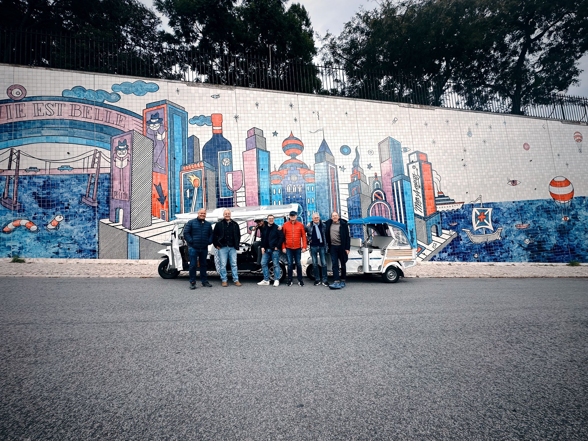 Tukxi street art tour Lisbon — electric tuk tuk with guests exploring Lisbon's vibrant urban art scene