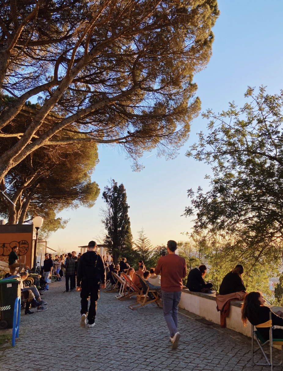 Lisbon at golden hour from a Tagus viewpoint — private sunset tuk tuk tour through the city's most scenic hilltop terraces